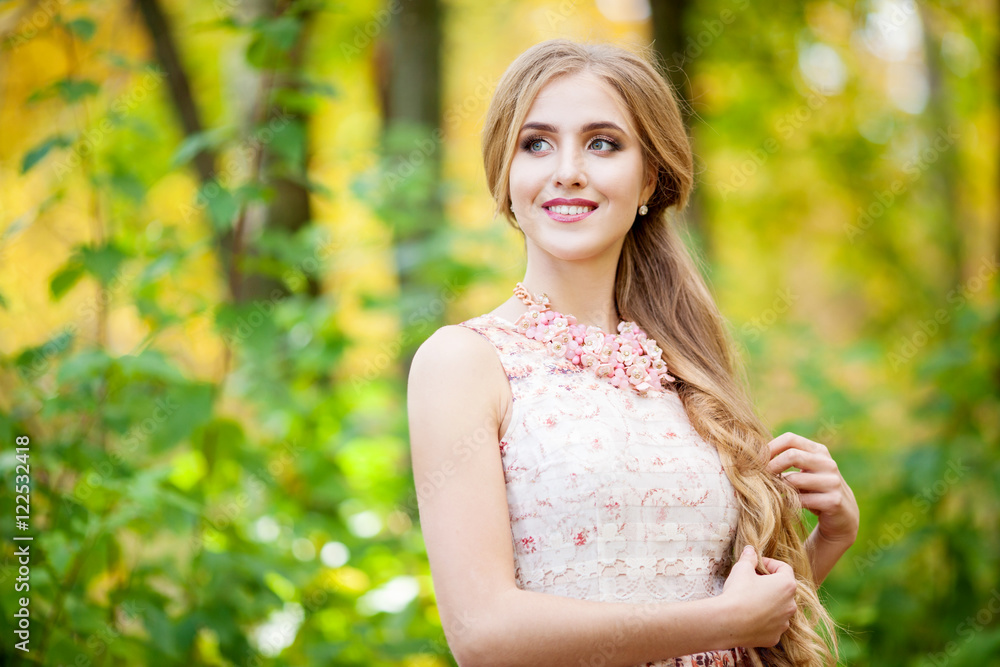 Beautiful girl with a sweet smile and long hair braids plait autumn day in the park Beautiful girl with a sweet smile and long hair braids plait autumn day in the park