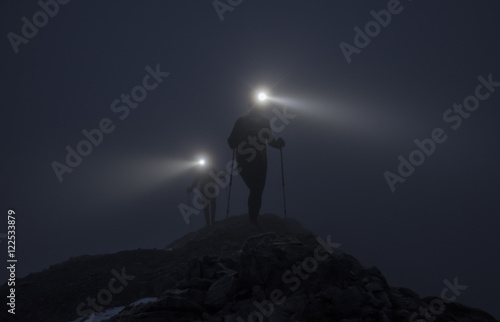 Two climbers and light beams on ridge © Chris