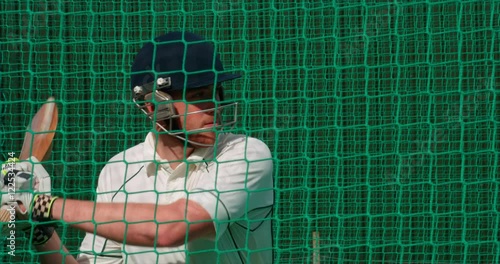 Cricketer hits cricket ball towards camera
