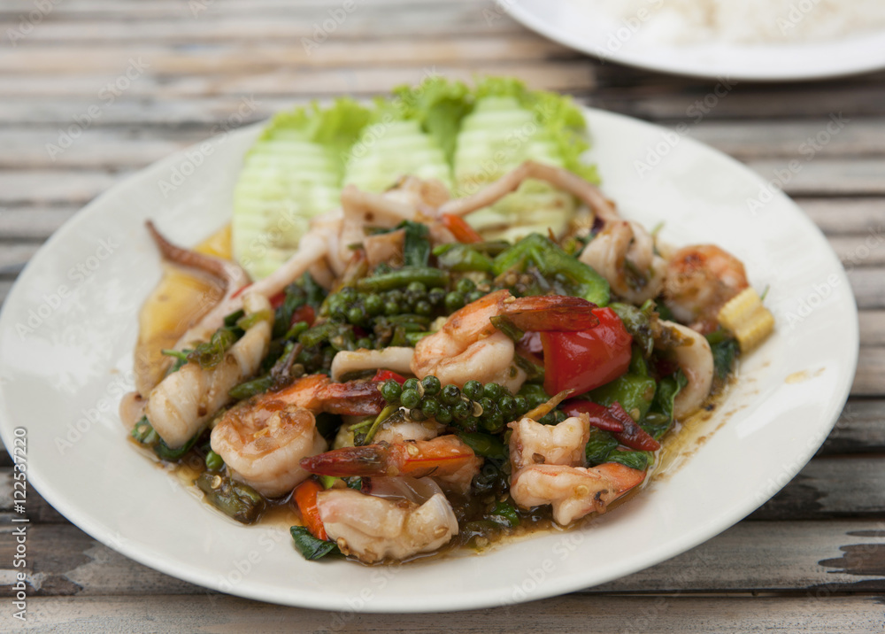 Colorful Thailand seafood salad with freshly-caught seafood and vegetables made at authentic Thai seafood restaurant on Koh Samet island in the Gulf of Thailand. Colorful Thailand seafood salad with freshly-caught seafood and vegetables made at authentic Thai seafood restaurant on Koh Samet island in the Gulf of Thailand.