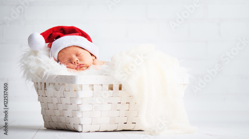 sleeper newborn baby in  Christmas Santa cap