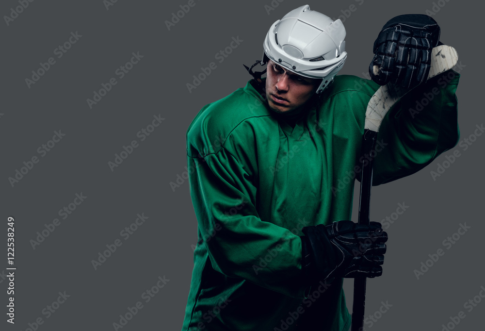 Naklejka premium Hockey player holds gaming stick.