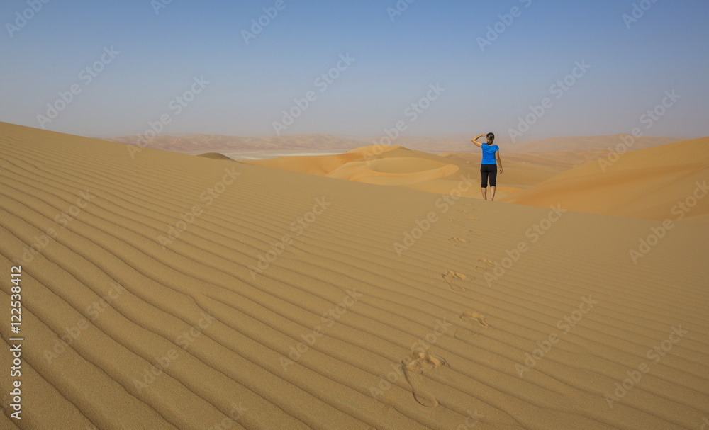 Woman walking in a desert