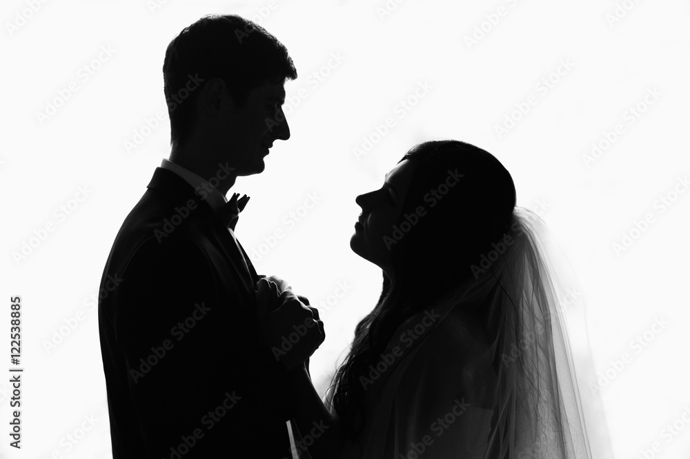 Black and white silhouette of elegant bride and goom on isolated white background