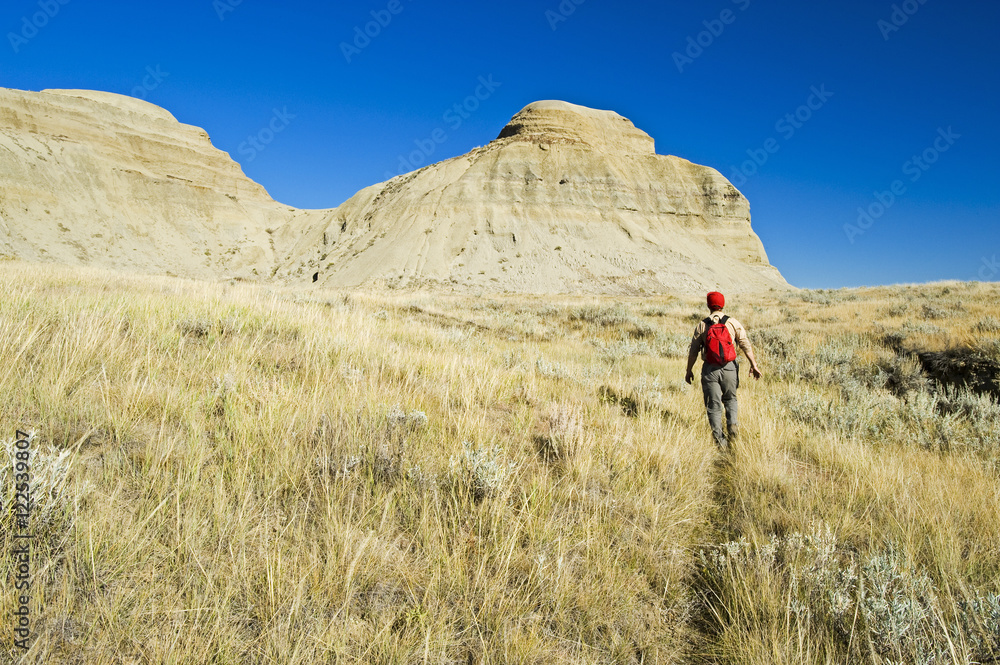 A hiker in the Killdeer Badlands, East Block, Grasslands National Park, Saskatchewan, Canada A hiker in the Killdeer Badlands, East Block, Grasslands National Park, Saskatchewan, Canada