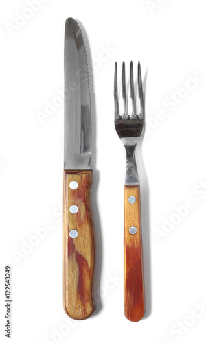 A knife and fork with wooden handles isolated on a white background