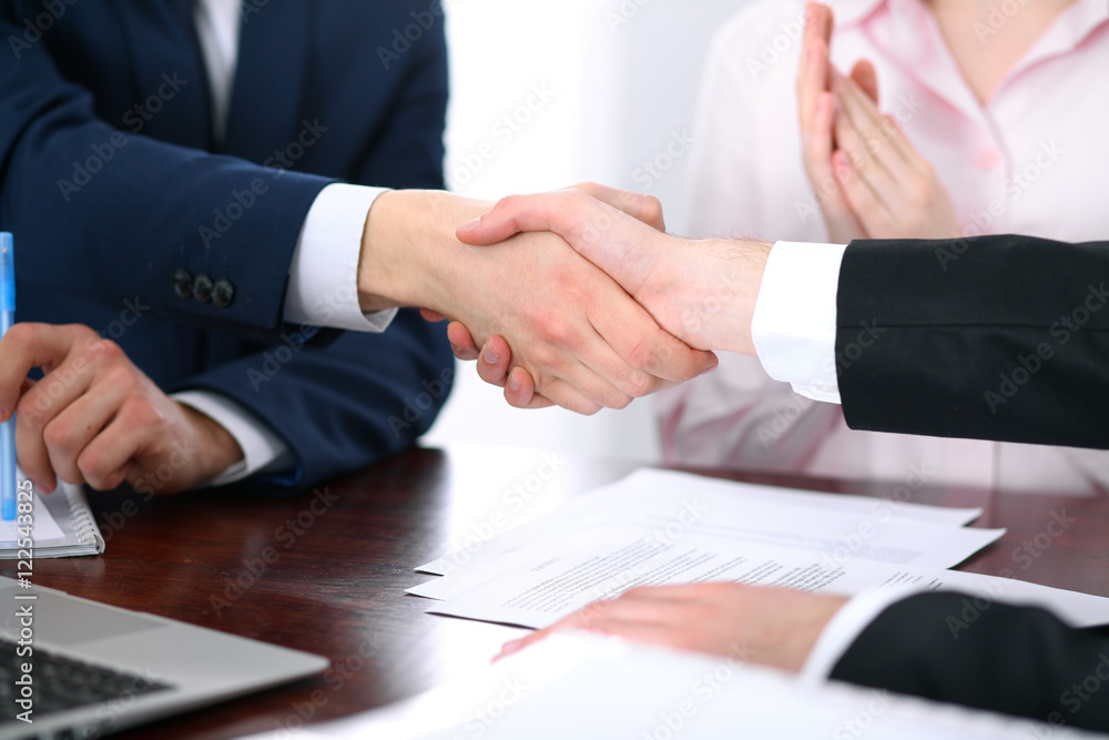 Business people shaking hands finishing up a meeting Business people shaking hands finishing up a meeting