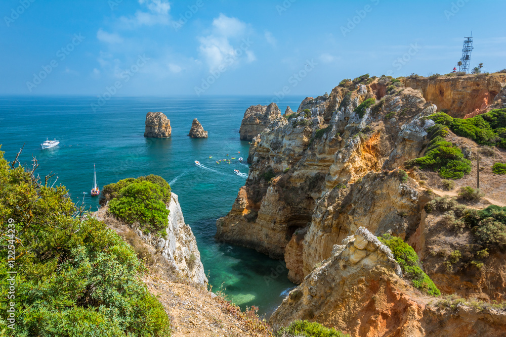 Fototapeta premium Scenic golden cliffs and emerald water in Ponta da Piedade, Lagos, Algarve, Portugal
