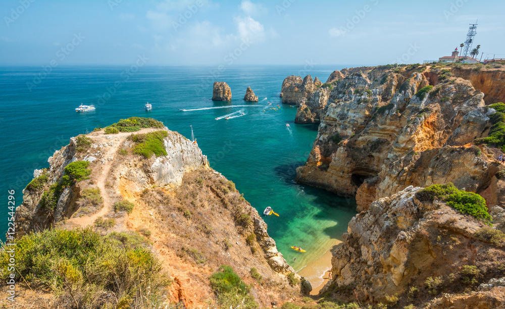 Scenic golden cliffs and emerald water in Ponta da Piedade, Lagos, Algarve, Portugal
