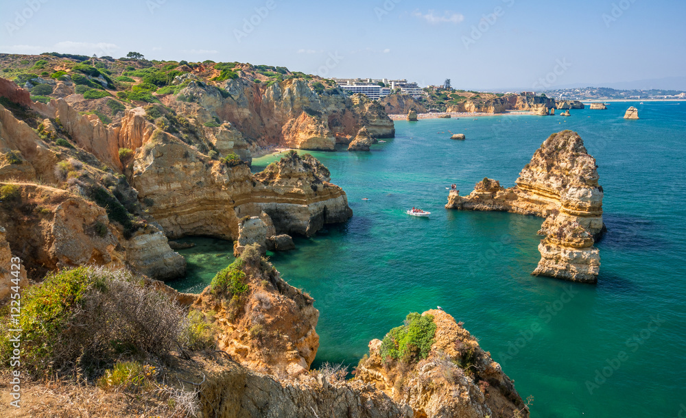 Fototapeta premium Scenic golden cliffs and emerald water in Ponta da Piedade, Lagos, Algarve, Portugal