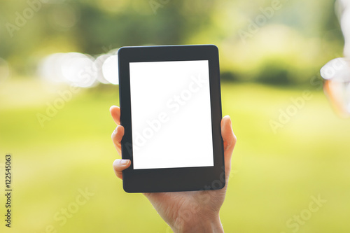 Female hand holding white tablet