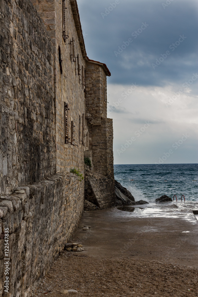 Waves breaking on the stone walls of the old fortress Waves breaking on the stone walls of the old fortress