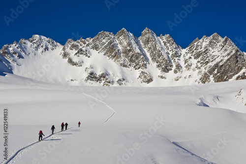 A group of ski tourers at Roger's Pass heading towards the Swiss Peaks, Glacier National Park, BC