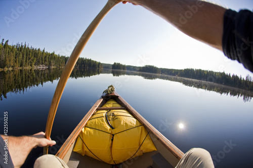 A young man canoeing and camping for 2 weeks in Wabakimi Provincial Park, Northern Ontario, Canada photo