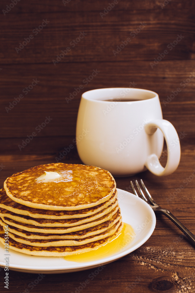 Stack of tasty pancakes with butter and honey for breakfast Stack of tasty pancakes with butter and honey for breakfast
