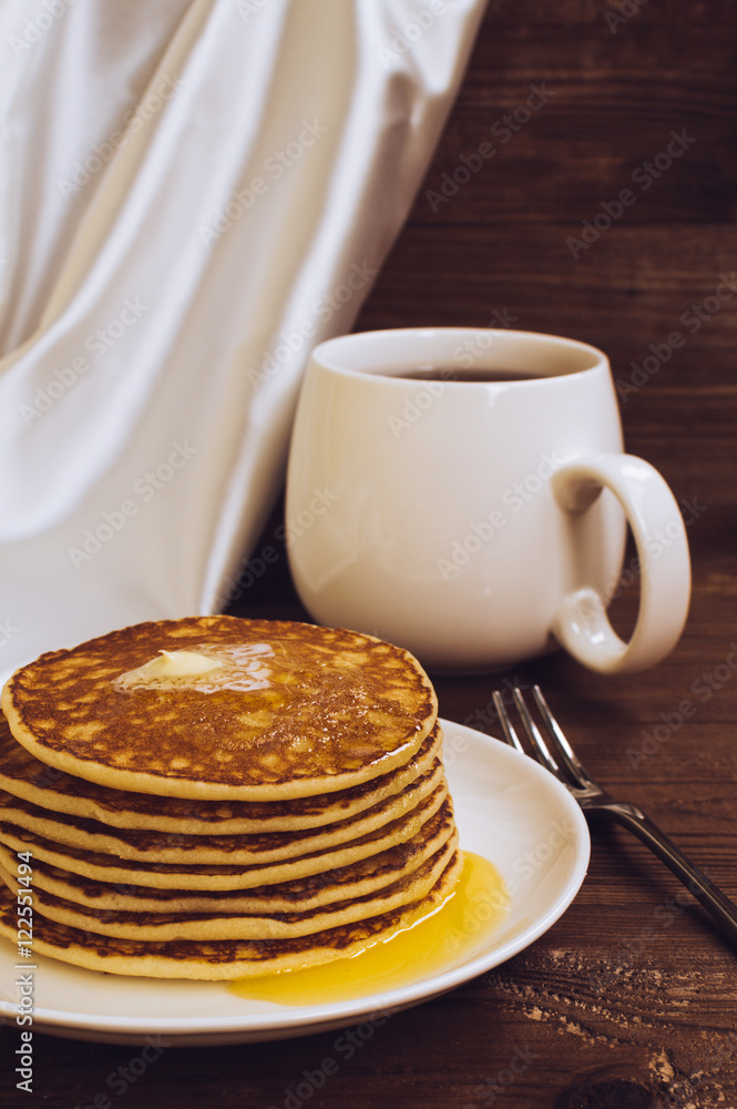 Stack of tasty pancakes with butter and honey for breakfast Stack of tasty pancakes with butter and honey for breakfast