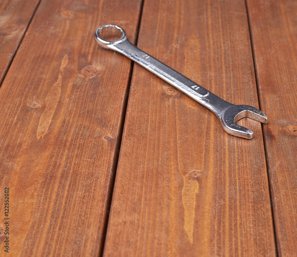 Wrench chrome metal spanner instrument on wooden surface Wrench chrome metal spanner instrument on wooden surface