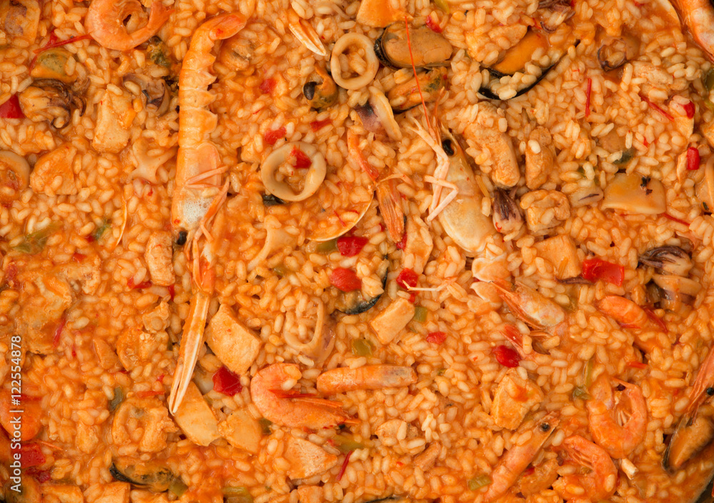 Seafood paella on a wooden blue background