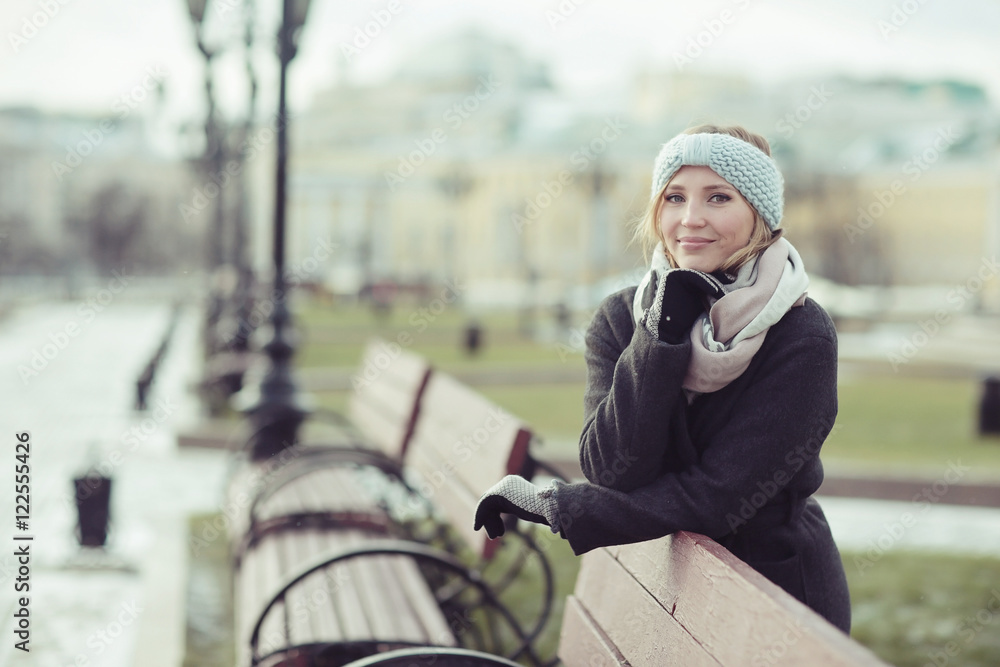 Fototapeta premium Dreaming woman in winter city a festive mood