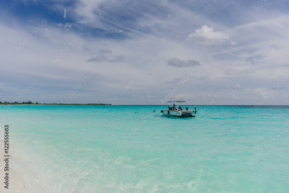 The boat in t the Caribbean Sea and the view of the beach of Cayo Largo, Cuba out of the water The boat in t the Caribbean Sea and the view of the beach of Cayo Largo, Cuba out of the water