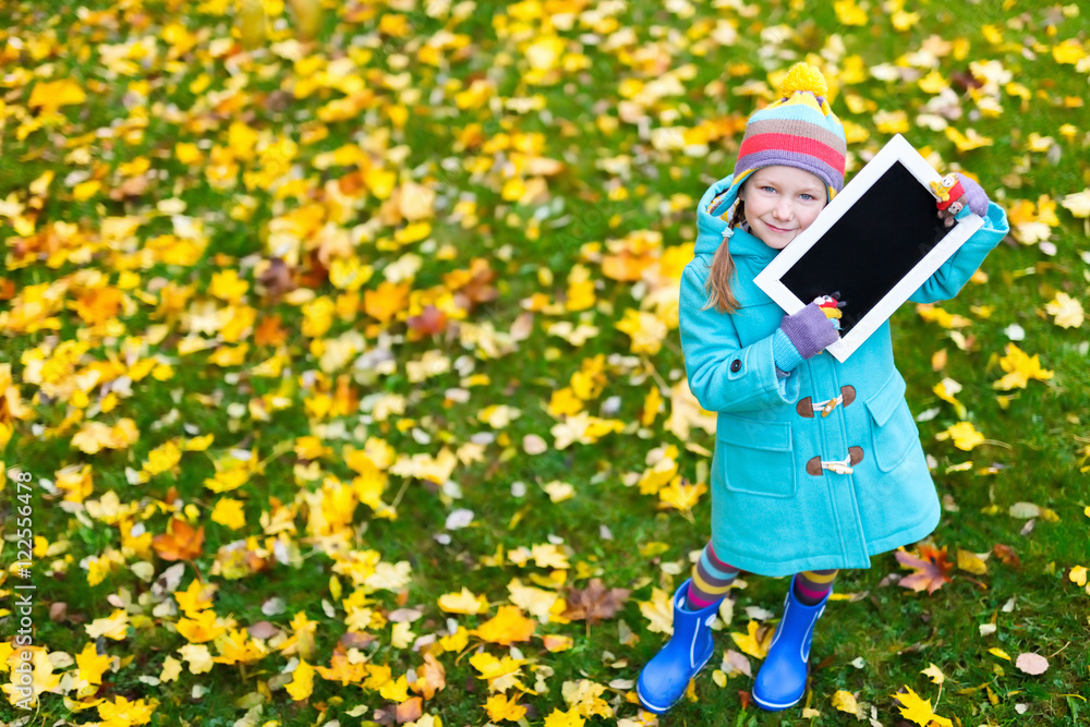 Little girl outdoors on autumn day