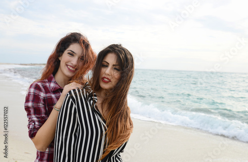 gossip girls smiling on the beach
