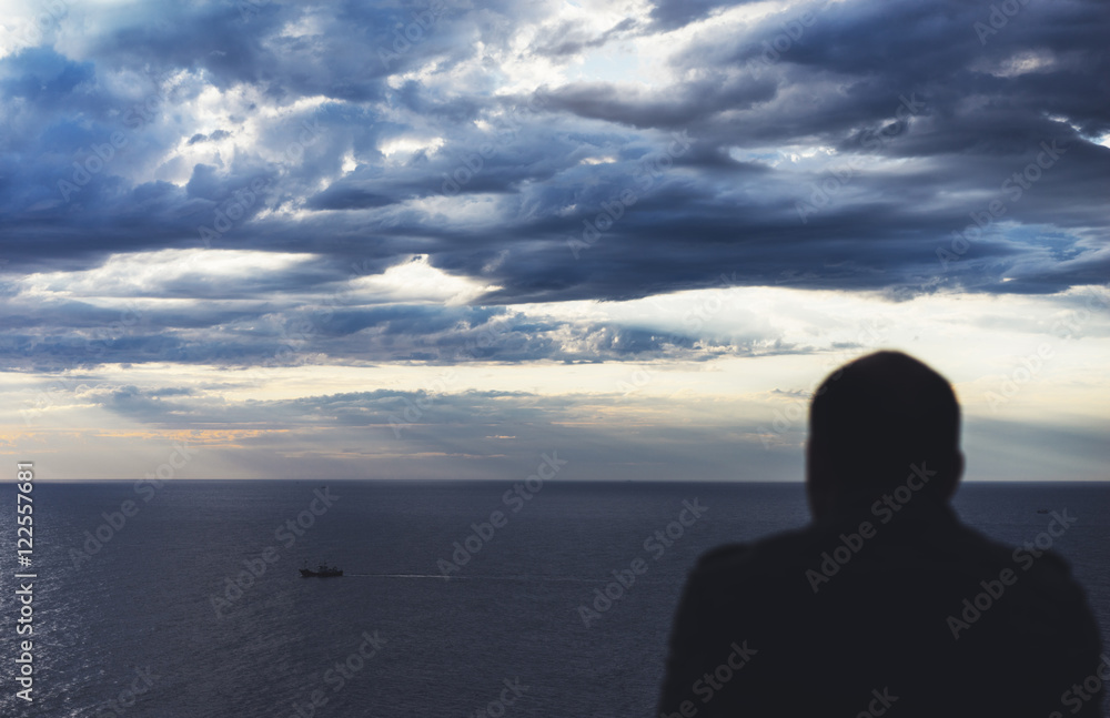 Clouds blue sky and sunlight sunset on horizon ocean Northern Spain Basque Country. Outline looking travel hipster on background seascape dramatic rays sunrise. Relax view waves sea Clouds blue sky and sunlight sunset on horizon ocean Northern Spain Basque Country. Outline looking travel hipster on background seascape dramatic rays sunrise. Relax view waves sea