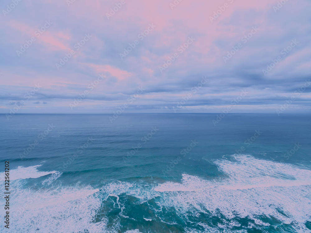 Aerial view of ocean surf at sunrise