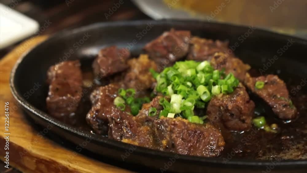 Japanese harami beef steak cut on sizzling pan in Izakaya restaurant style Japanese harami beef steak cut on sizzling pan in Izakaya restaurant style