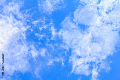 Blue sky background with white clouds. The vast blue sky and clouds sky on sunny day. White fluffy clouds in the blue sky.