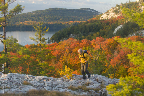 A male hiker on white quartzite ridges in Killarney Provincial Park, Ontario, Canada photo