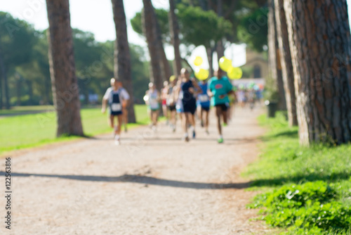 runners in marathon in a park abstract  blurry  