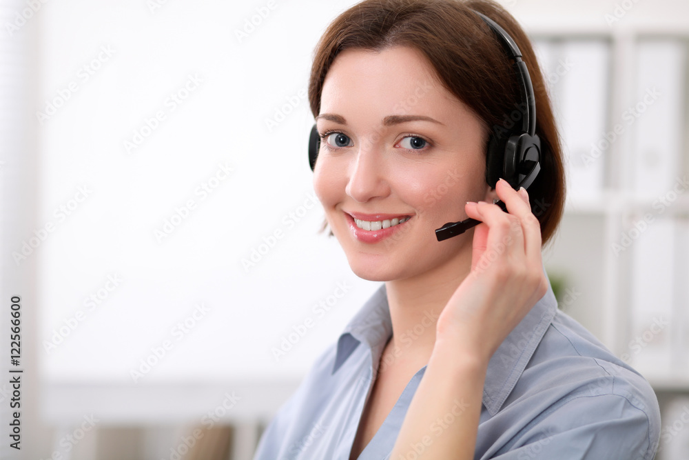 Young beautiful business woman in headset. Call center. Young beautiful business woman in headset. Call center.