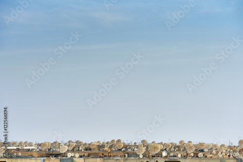 Lots of satellite dishes on rooftops