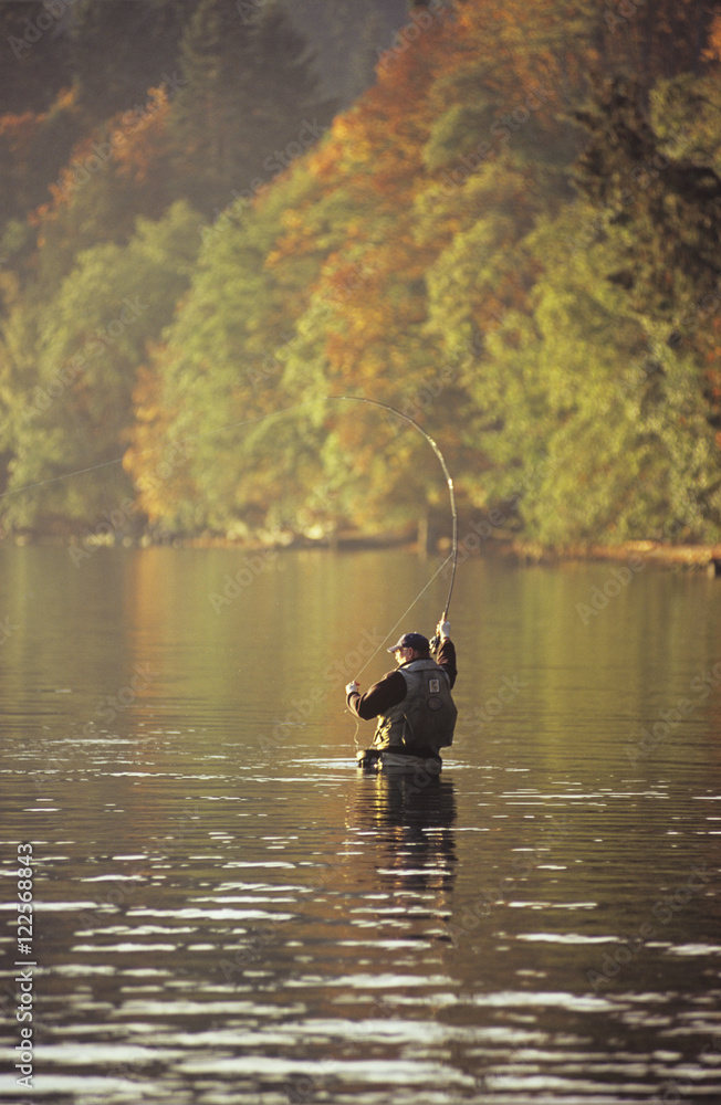 Man fly fishing in autumn, Cherry Point, Vancouver Island, British Columbia, Canada. Man fly fishing in autumn, Cherry Point, Vancouver Island, British Columbia, Canada.