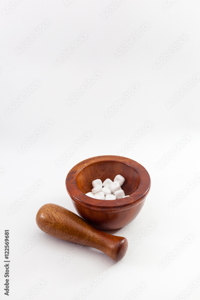 mortar, pestle and medicines on white background