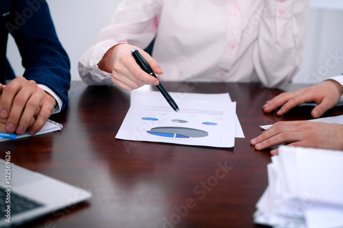 Group of business people at meeting discussing financial results