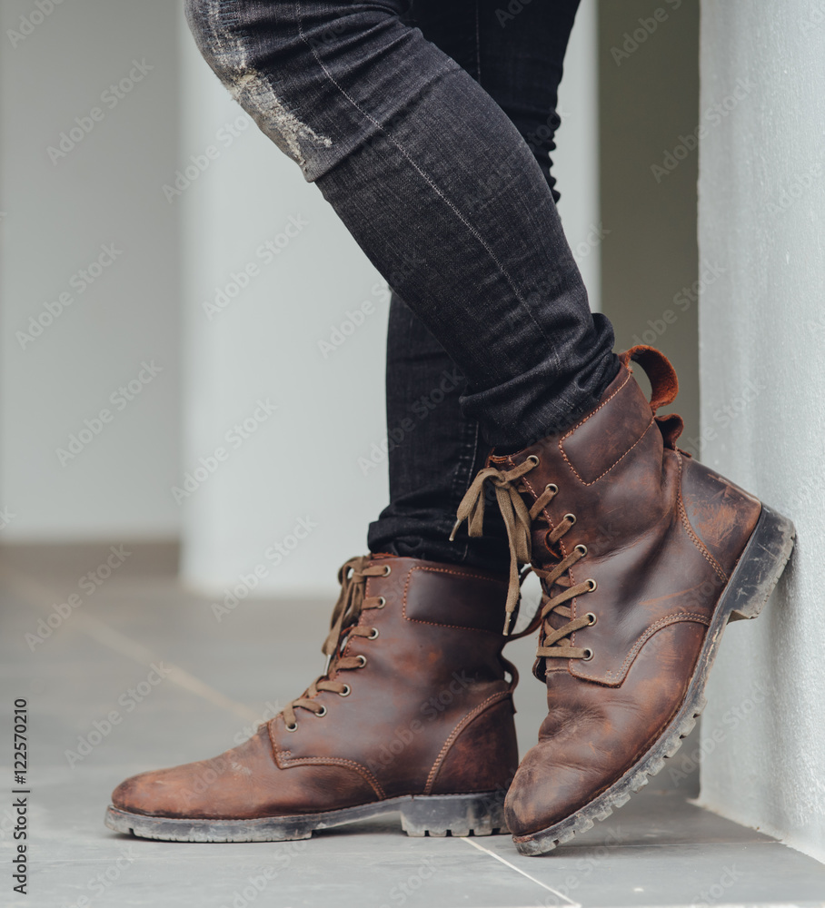 Stockfoto Men fashion, man's legs in black jeans and brown leather boots. |  Adobe Stock