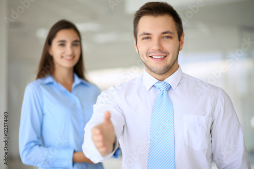 Wallpaper Mural Smiling businessman  in office is ready for shaking hands Torontodigital.ca