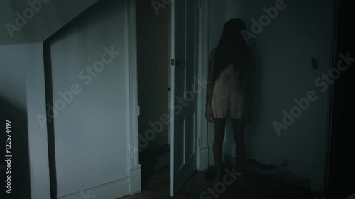 Creepy possessed girl twitching behind a door