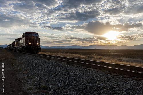 Train on tracks at sunrise.