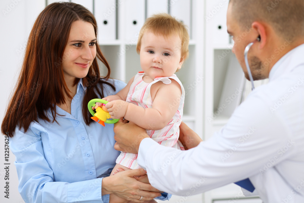Happy cute baby with her mother at health exam at doctor's office. Happy cute baby with her mother at health exam at doctor's office.