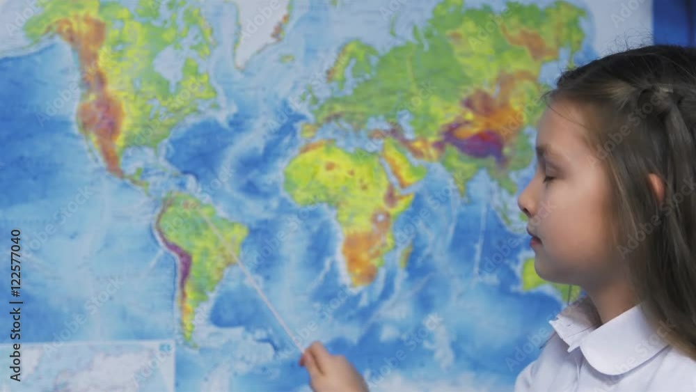 Elementary School Student Smiles by world map. Elementary School Student Smiles by world map.