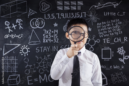 Boy with doodle and magnifying glass