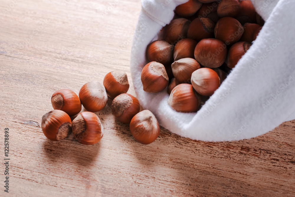 The white bag with the unshelled nuts The white bag with the unshelled nuts