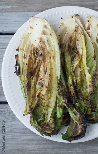 Grilled romaine lettuce on a  white plate 