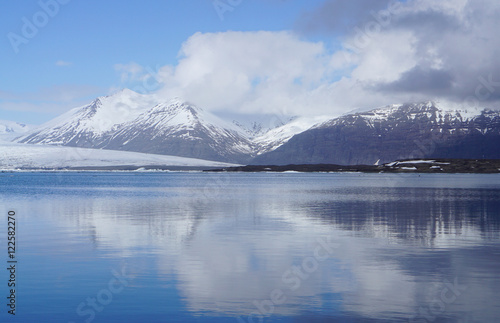 ice sheet on the water with snow mountain background © augustcindy