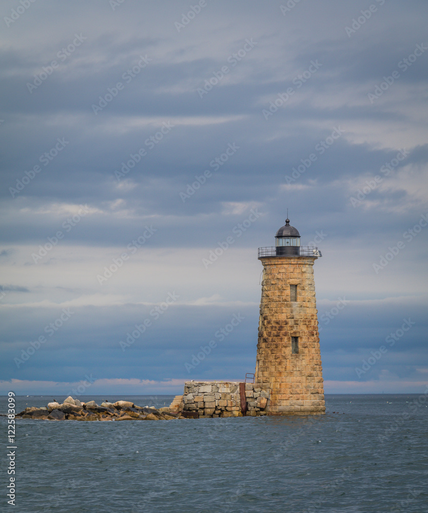 Whaleback Lighthouse in Kittery, Maine, on a cloudy foggy day in early Fall, portrait
