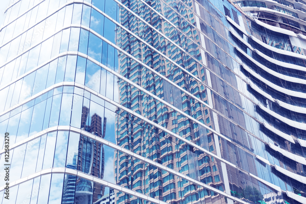 Glass of modern tower with sky reflection for business backgroun Glass of modern tower with sky reflection for business backgroun