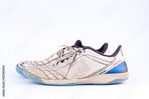 Old blue worn out futsal sports shoes on white background isolated 